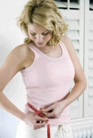 Black Latte - effective weight loss with the help of active carbon 2 a woman measures her waist circumference