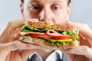  a man eats a sandwich