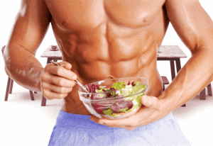  A muscular man eats a salad