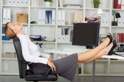 How to stay in shape while working in the office? 4 woman keeps her feet on the desk