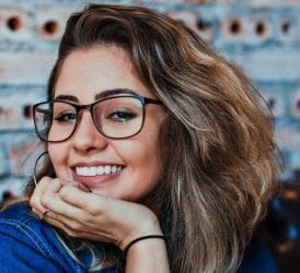  a woman in glasses with white teeth