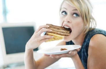  a woman eats a sandwich