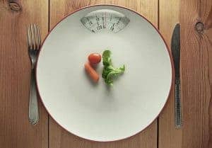  vegetables and cutlery on the scale 