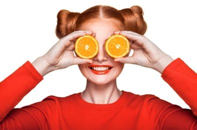  woman with orange fruit