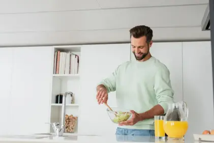  a man makes a healthy salad