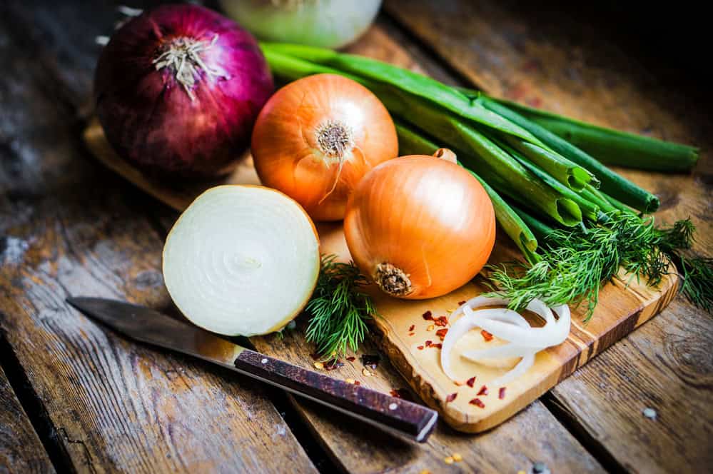Onions - full of health with a specific smell and taste 3 Onions on the board